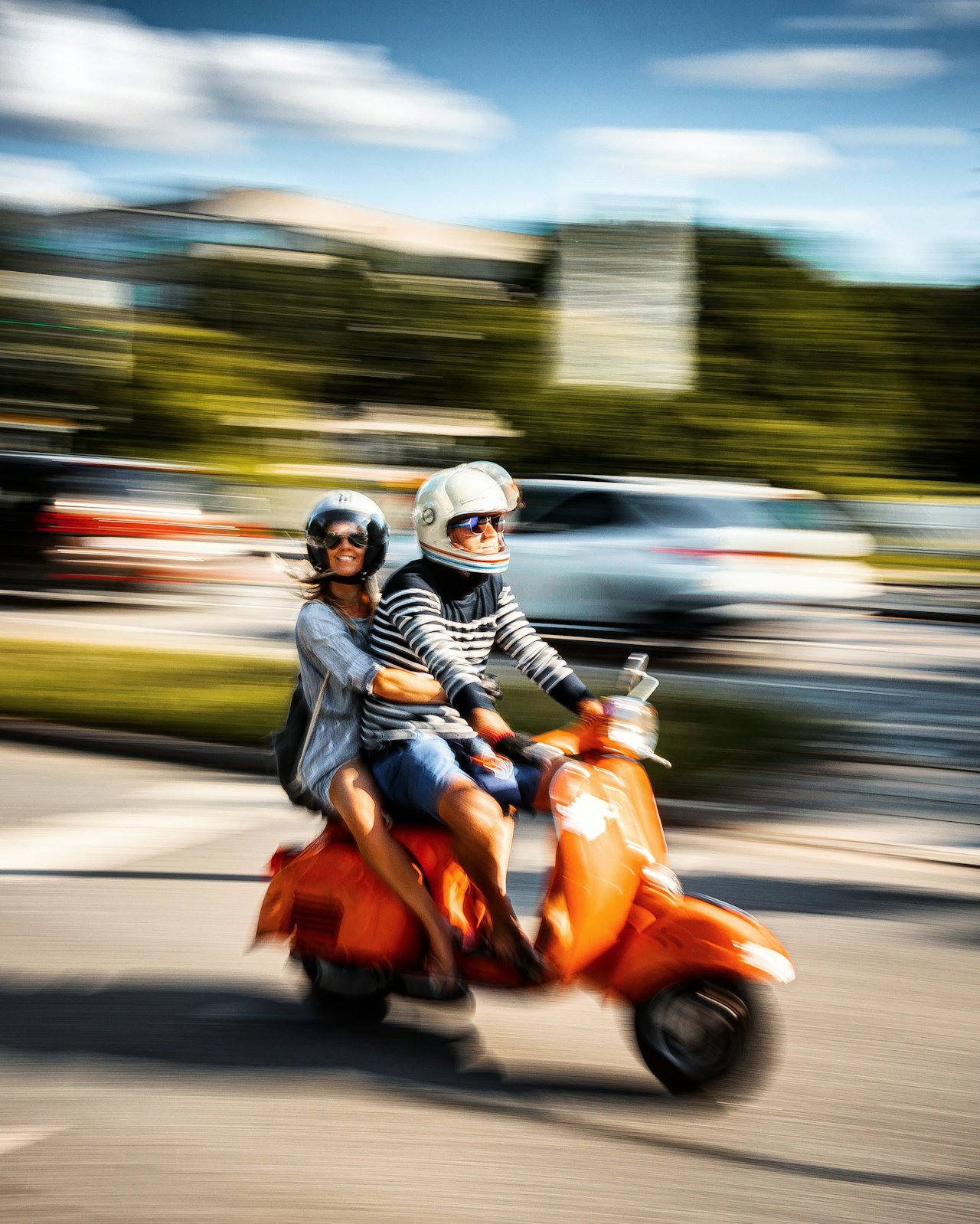 A commuter parked beside a small scooter at a UK railway station during the morning rush